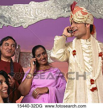 Stock Photo - indian groom on 
cellphone, standing 
with wedding party. 
fotosearch - search 
stock photos, 
pictures, images, 
and photo clipart