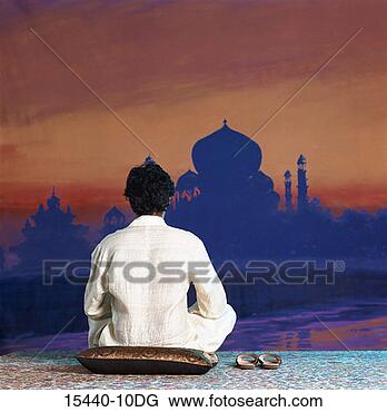 Stock Photo - man seated on 
pillow facing 
taj mahal backdrop, 
rear view. fotosearch 
- search stock 
photos, pictures, 
images, and photo 
clipart