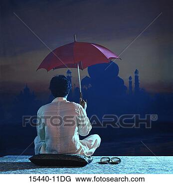 Stock Photo - man seated on 
pillow holding 
umbrella facing 
taj mahal backdrop. 
fotosearch - search 
stock photos, 
pictures, images, 
and photo clipart