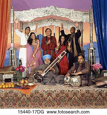 Stock Photo - women and men 
dancing behind 
man playing sitar 
and man playing 
drums. fotosearch 
- search stock 
photos, pictures, 
images, and photo 
clipart