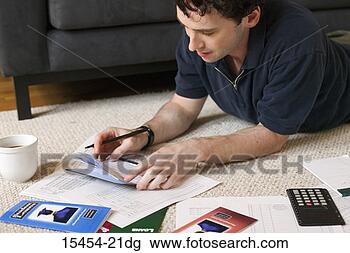 Stock Photo - man on floor examining 
checkbook. fotosearch 
- search stock 
photos, pictures, 
images, and photo 
clipart