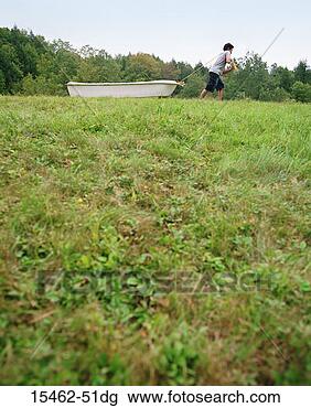 Stock Photo - man dragging boat 
in field. fotosearch 
- search stock 
photos, pictures, 
images, and photo 
clipart