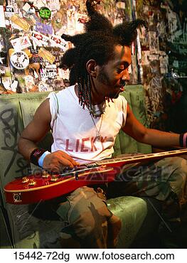 Stock Photo - rock performer 
changing guitar 
string backstage. 
fotosearch - search 
stock photos, 
pictures, images, 
and photo clipart