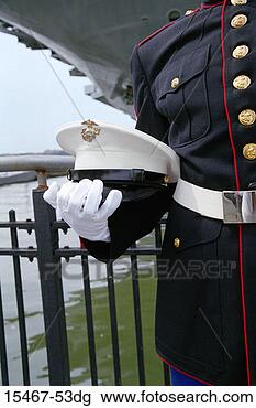 Stock Photo - marine's hand 
holding hat near 
the intrepid battleship. 
fotosearch - search 
stock photos, 
pictures, images, 
and photo clipart