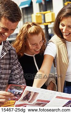 Stock Photo - mother, dad and 
daughter reading 
tourist brochure. 
fotosearch - search 
stock photos, 
pictures, images, 
and photo clipart