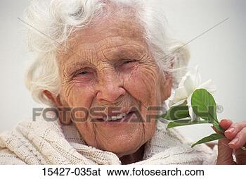 Stock Photo - elderly woman 
with gardenia, 
headshot. fotosearch 
- search stock 
photos, pictures, 
images, and photo 
clipart