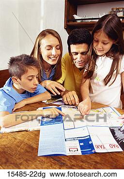 Stock Photo - family looking 
at brochure. fotosearch 
- search stock 
photos, pictures, 
images, and photo 
clipart