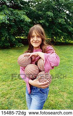 Stock Photo - girl holding several 
balls. fotosearch 
- search stock 
photos, pictures, 
images, and photo 
clipart