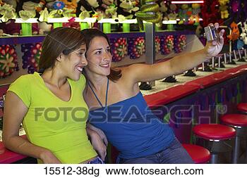 Stock Photo - friends taking 
a picture of themselves. 
fotosearch - search 
stock photos, 
pictures, images, 
and photo clipart