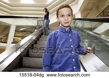 Stock Photo - young boy on escalator. 
fotosearch - search 
stock photos, 
pictures, images, 
and photo clipart