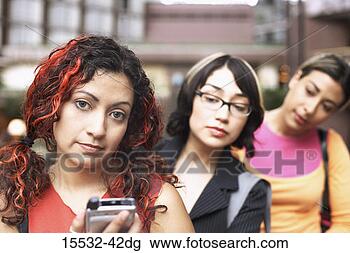 Stock Photo - two women watching 
a woman using 
pda. fotosearch 
- search stock 
photos, pictures, 
images, and photo 
clipart