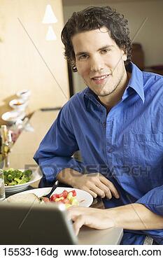 Stock Photo - man on laptop 
with food. fotosearch 
- search stock 
photos, pictures, 
images, and photo 
clipart