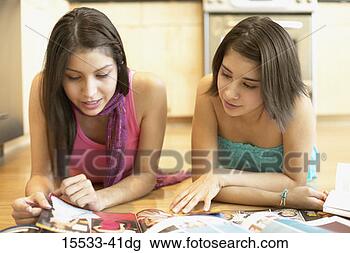 Stock Photo - two women looking 
at magazines. 
fotosearch - search 
stock photos, 
pictures, images, 
and photo clipart