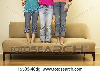 Stock Photo - waist-down view 
of three women 
standing on couch. 
fotosearch - search 
stock photos, 
pictures, images, 
and photo clipart