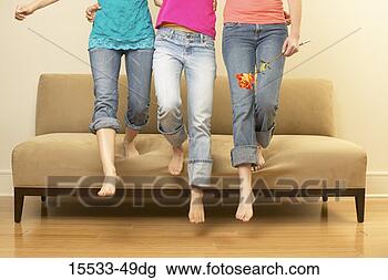 Stock Photo - waist-down view 
of three women 
stepping off couch. 
fotosearch - search 
stock photos, 
pictures, images, 
and photo clipart