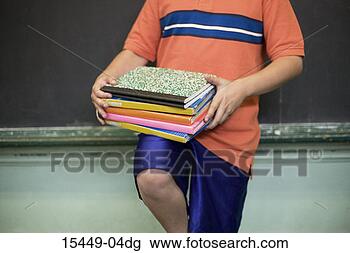 Stock Photo - boy balancing 
school book on 
knee, by blackboard. 
fotosearch - search 
stock photos, 
pictures, images, 
and photo clipart