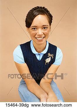 Stock Photo - young woman seated. 
fotosearch - search 
stock photos, 
pictures, images, 
and photo clipart