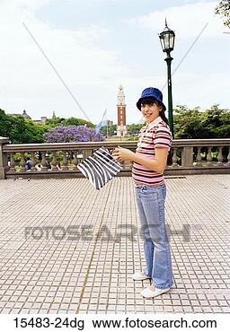 Stock Photo - girl smiling in 
square holding 
shopping bag in 
buenos aires. 
fotosearch - search 
stock photos, 
pictures, images, 
and photo clipart
