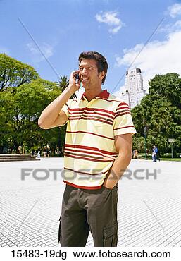 Stock Photo - man standing talking 
on cell phone 
in square in buenos 
aires. fotosearch 
- search stock 
photos, pictures, 
images, and photo 
clipart