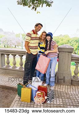 Stock Photo - man,  woman,  
and girl posing 
on balcony with 
shopping bags 
in buenos. fotosearch 
- search stock 
photos, pictures, 
images, and photo 
clipart