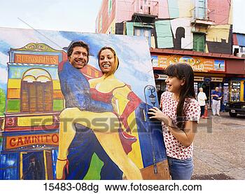 Stock Photo - man and woman 
posing with heads 
through placard 
on street in buenos. 
fotosearch - search 
stock photos, 
pictures, images, 
and photo clipart