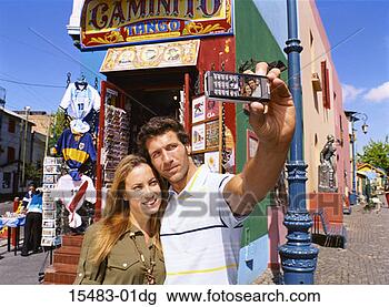 Stock Photo - man and woman 
taking self-portrait 
photo with camera 
phone on street. 
fotosearch - search 
stock photos, 
pictures, images, 
and photo clipart