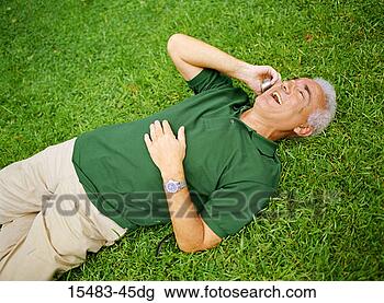Stock Photo - older man lying 
on grass talking 
on cell phone 
in buenos aires. 
fotosearch - search 
stock photos, 
pictures, images, 
and photo clipart