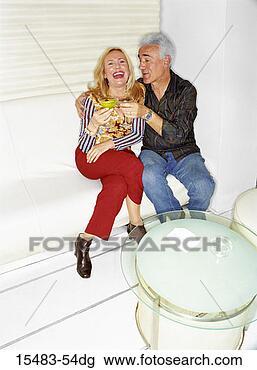 Stock Photo - older man and 
woman sitting 
in nightclub together 
drinking martinis. 
fotosearch - search 
stock photos, 
pictures, images, 
and photo clipart