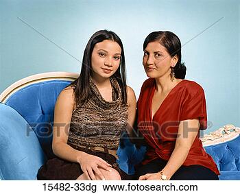 Banco de Imagem - dois,  latinas, 
 sentando,  sofá, 
 logo,  cada, 
 outro. fotosearch 
- busca de fotos, 
imagens e clipart