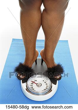 Stock Photo - close-up of plus-sized 
woman's legs, 
standing on a 
bathroom scale. 
fotosearch - search 
stock photos, 
pictures, images, 
and photo clipart