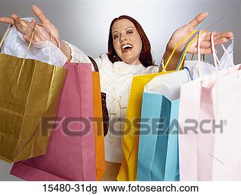 Stock Photo - plus-sized woman 
holding many shopping 
bags outstretched 
toward. fotosearch 
- search stock 
photos, pictures, 
images, and photo 
clipart