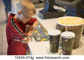 Stock Photo - boy at concession 
stand counter 
with popcorn and 
drinks. fotosearch 
- search stock 
photos, pictures, 
images, and photo 
clipart