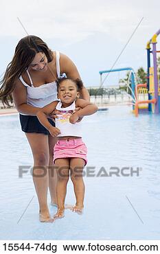 Stock Photo - mother and daughter 
in wading pool 
at waterpark. 
fotosearch - search 
stock photos, 
pictures, images, 
and photo clipart
