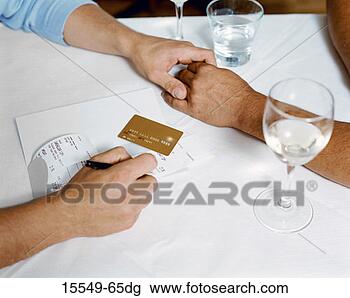 Stock Photo - couple holding 
hands at table. 
fotosearch - search 
stock photos, 
pictures, images, 
and photo clipart