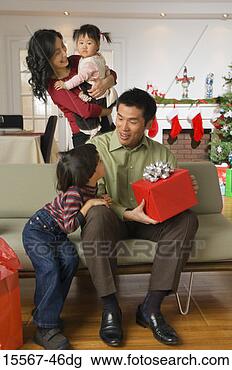 Stock Photo - family celebrating 
christmas. fotosearch 
- search stock 
photos, pictures, 
images, and photo 
clipart