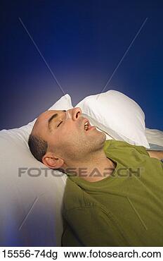 Stock Photo - man asleep wearing 
a nasal breathing 
strip. fotosearch 
- search stock 
photos, pictures, 
images, and photo 
clipart