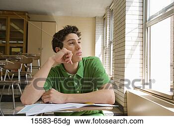 Stock Photo - teenage boy daydreaming 
in classroom. 
fotosearch - search 
stock photos, 
pictures, images, 
and photo clipart