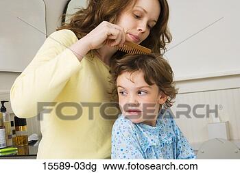 Stock Photo - mother combing 
daughter's hair. 
fotosearch - search 
stock photos, 
pictures, images, 
and photo clipart