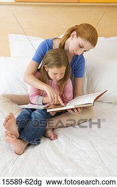 Stock Photo - mother and daughter 
reading in bed. 
fotosearch - search 
stock photos, 
pictures, images, 
and photo clipart