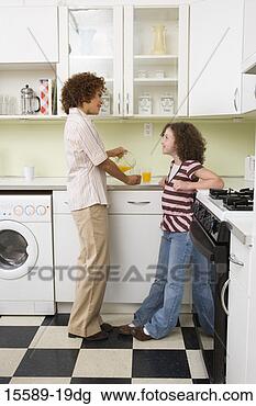 Stock Photo - mother and daughter 
talking in kitchen. 
fotosearch - search 
stock photos, 
pictures, images, 
and photo clipart