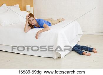 Stock Photo - mother lying on 
bed with daughter 
lying under bed. 
fotosearch - search 
stock photos, 
pictures, images, 
and photo clipart