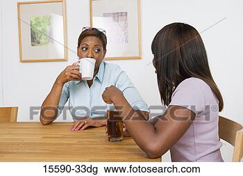 Stock Photo - mother and daughter 
having beverages 
together. fotosearch 
- search stock 
photos, pictures, 
images, and photo 
clipart