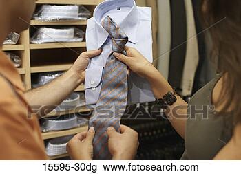 Stock Photo - couple shopping 
for men's clothing 
together. fotosearch 
- search stock 
photos, pictures, 
images, and photo 
clipart