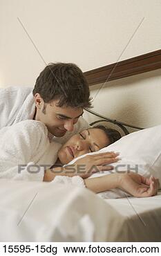 Stock Photo - man looking at 
sleeping woman 
in bed. fotosearch 
- search stock 
photos, pictures, 
images, and photo 
clipart