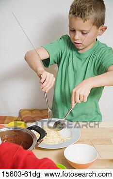 Stock Photo - boy eating pasta 
at table. fotosearch 
- search stock 
photos, pictures, 
images, and photo 
clipart