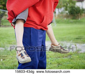 Stock Photo - boy giving piggyback 
ride. fotosearch 
- search stock 
photos, pictures, 
images, and photo 
clipart