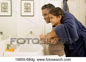 Stock Photo - father and daughter 
smiling into bathroom 
mirror. fotosearch 
- search stock 
photos, pictures, 
images, and photo 
clipart