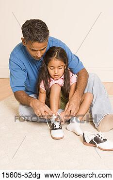 Stock Photo - father helping 
daughter tie shoes. 
fotosearch - search 
stock photos, 
pictures, images, 
and photo clipart