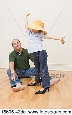 Stock Photo - girl playing dress-up 
in front of father. 
fotosearch - search 
stock photos, 
pictures, images, 
and photo clipart