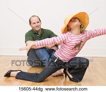 Stock Photo - girl playing dress-up 
in front of father. 
fotosearch - search 
stock photos, 
pictures, images, 
and photo clipart